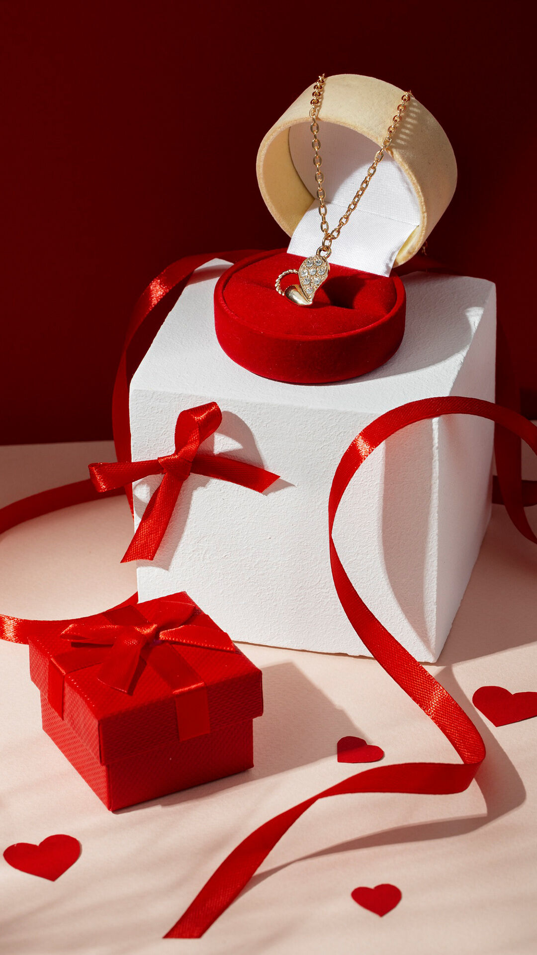 red gift box and red round shape necklace box with beautifull neclace in it